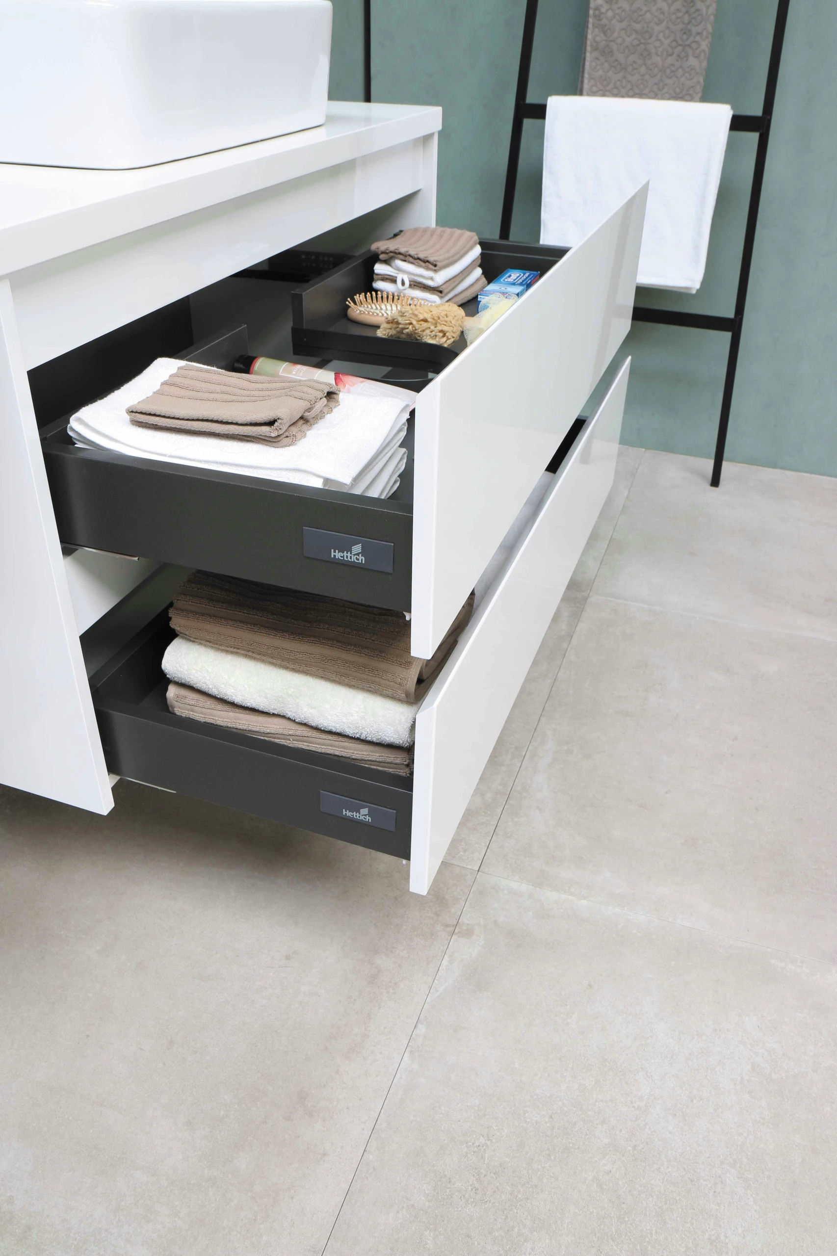 Modern and space-efficient vanity setup featuring sleek pull-out cabinets neatly organized with towels and toiletries, ideal inspiration for small bathroom ideas that combine functionality with minimal design.