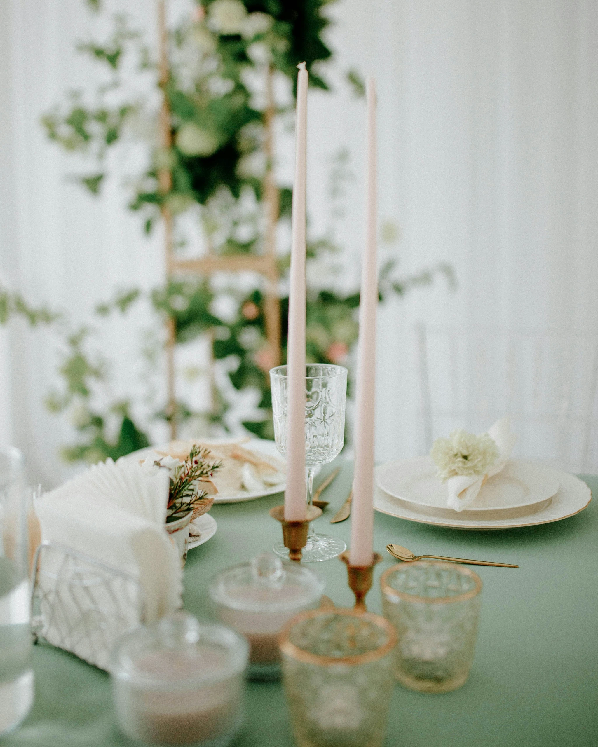 Elegant dining setup featuring two tall candlesticks as a minimalist centerpiece, offering refined dining table centerpiece ideas for intimate gatherings or romantic dinners.
