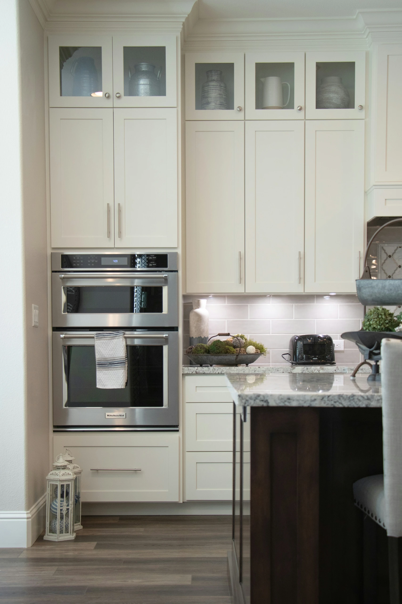 Elegant kitchen showcasing small kitchen decor ideas with clever storage solutions that utilize vertical space with hanging cabinets, offering both style and functionality in a compact layout.