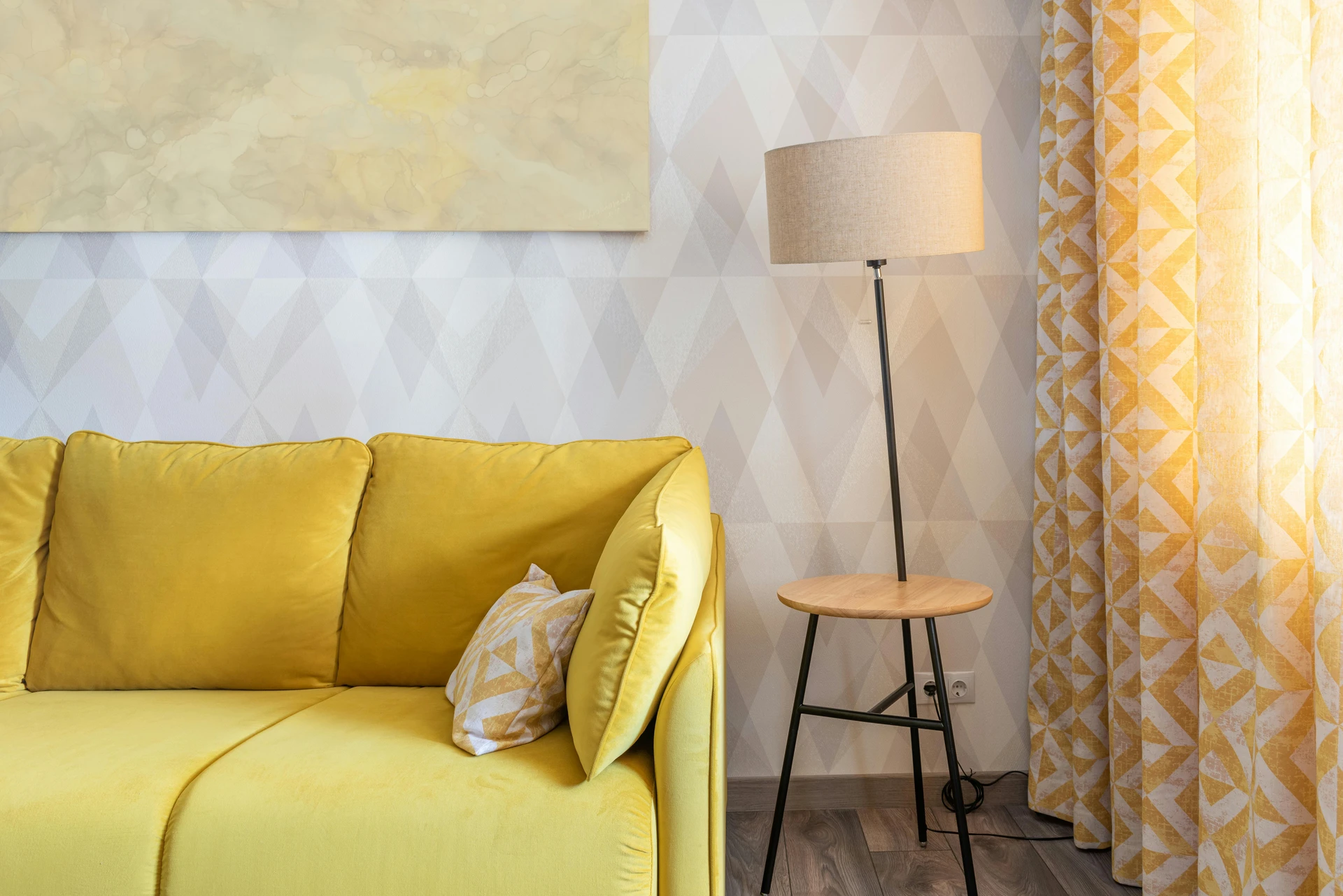 Bright curtain ideas for the living room featuring cheerful and colorful patterns in yellow and white, paired with a matching yellow sofa and accent pillow. The bold geometric design on the curtains adds energy and personality, creating a lively yet cozy space that feels both modern and inviting.