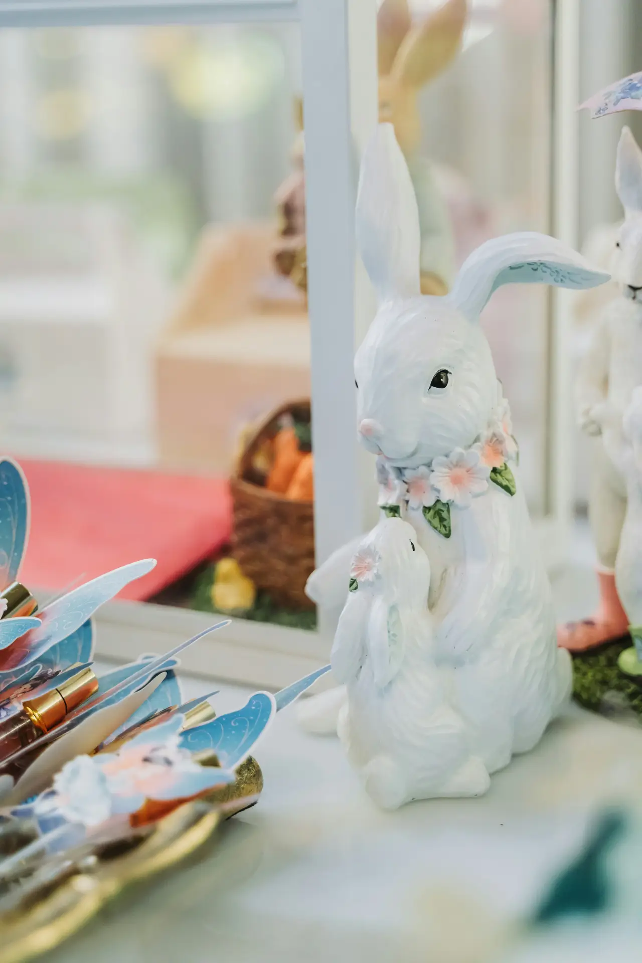 Easter decor ideas featuring detailed bunnies displayed on a bright surface, showing delicate facial features, floral accents, and a soft pastel color palette, styled as a charming seasonal vignette near a window with playful spring details nearby.