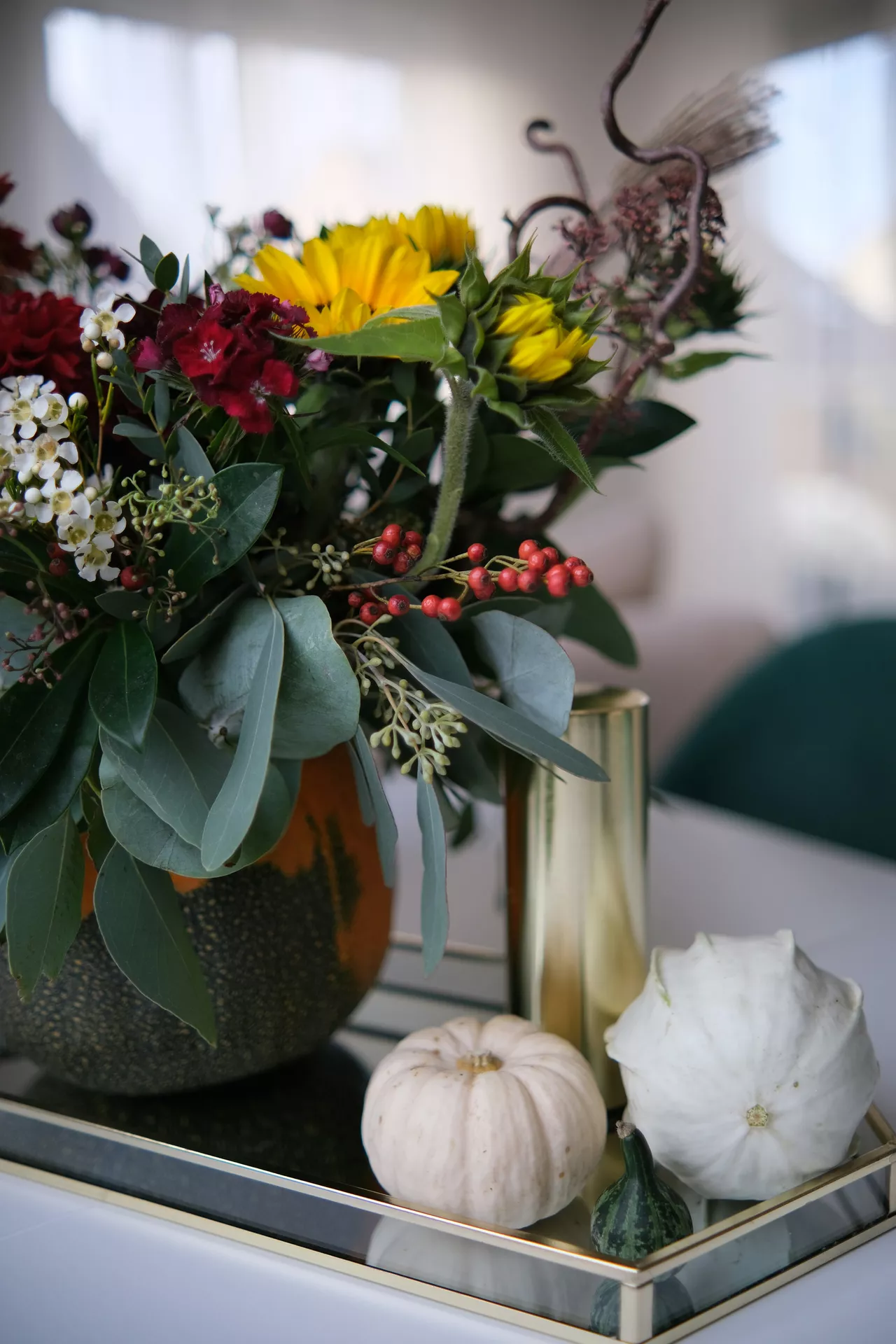 Fall tray decor ideas showcasing Fresh Fall Flowers & White Decor Pumpkins on a mirrored tray, featuring a vibrant autumn bouquet, elegant brass candle holder, and decorative gourds for a bright and sophisticated seasonal centerpiece.