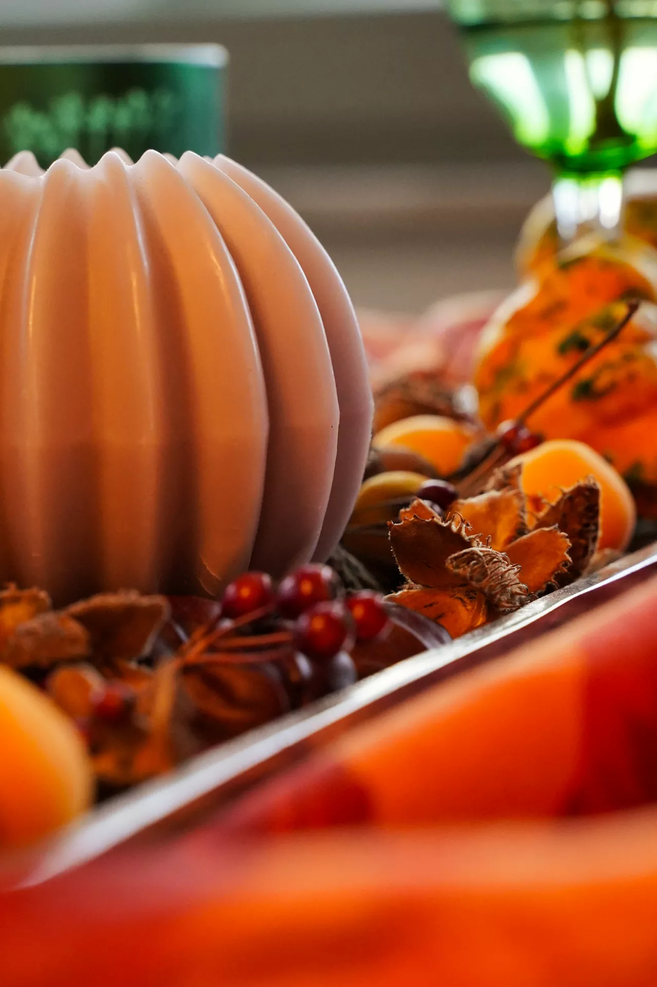 Fall tray decor ideas featuring a sculptural Round Candle, Leaves & Berries arranged on a decorative tray with dried orange slices, autumn leaves, red berries, mini gourds, and warm seasonal accents for an elegant fall centerpiece.